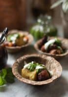 Pan fried sweet patatoes served with yogurt, mint chutney and tamarind chutney in a bowl