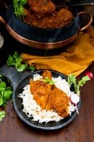 Chicken cooked in tomato sauce served on rice