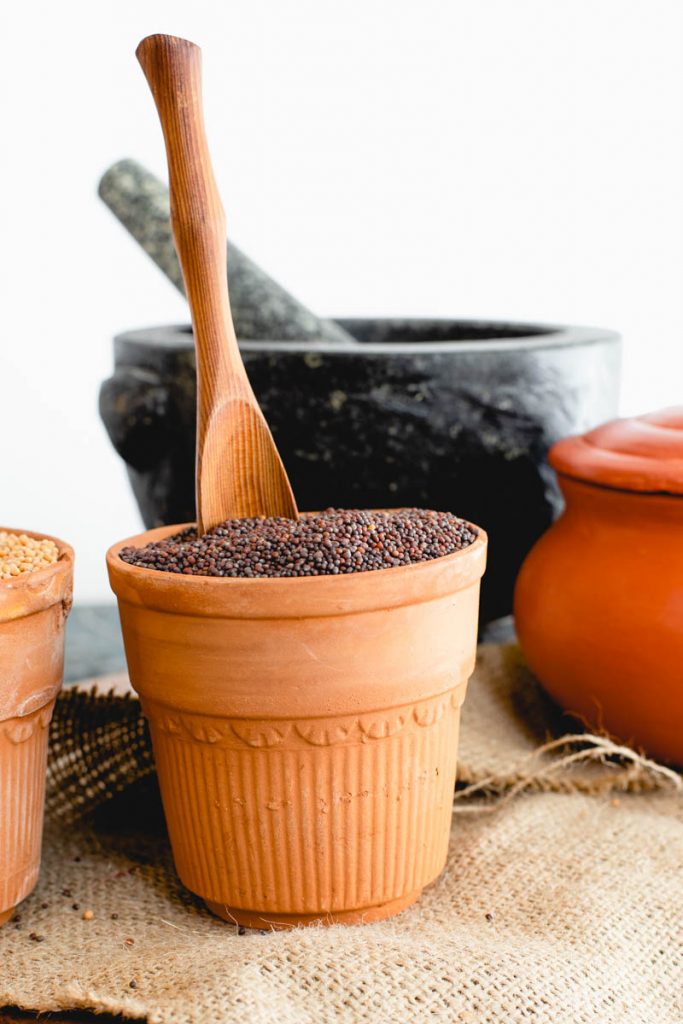 Brown mustard seeds in an earthen vase